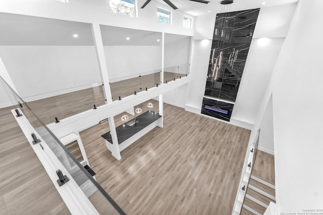 workout room featuring a towering ceiling and hardwood / wood-style flooring