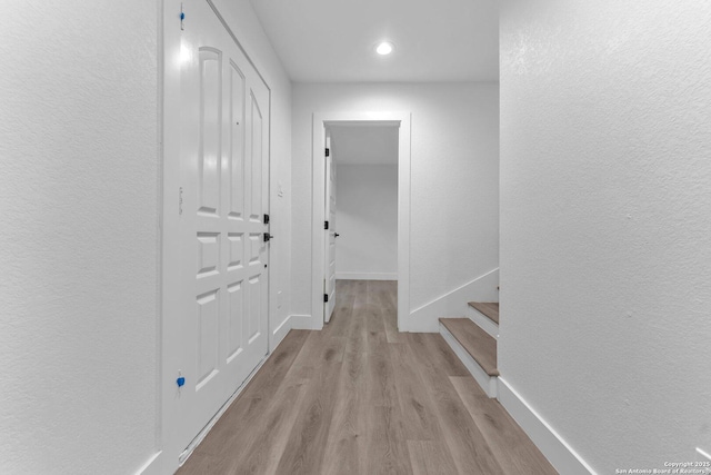 hall with light hardwood / wood-style floors