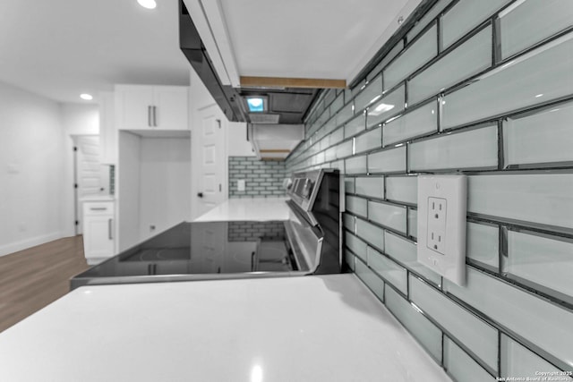 kitchen with backsplash and white cabinetry