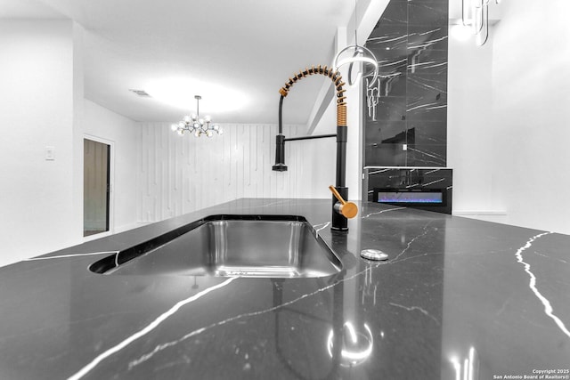 interior details featuring sink and an inviting chandelier