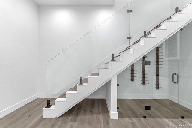 stairway with hardwood / wood-style floors