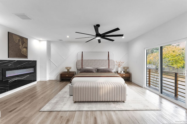 bedroom featuring access to outside, ceiling fan, and light hardwood / wood-style floors