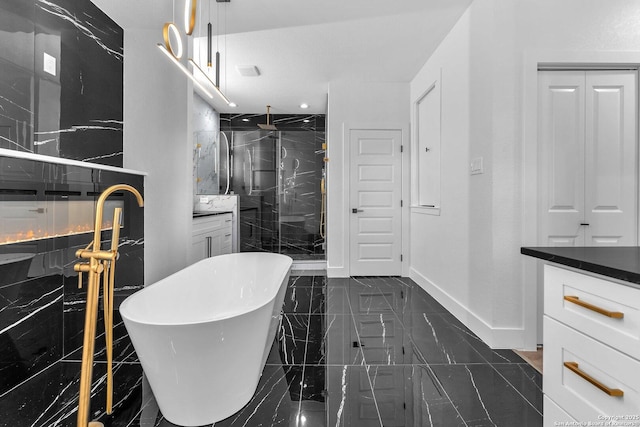 bathroom featuring vanity and shower with separate bathtub