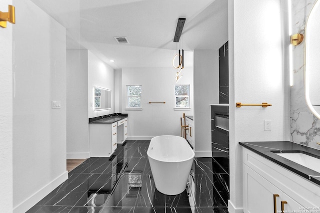 bathroom featuring vanity and a tub