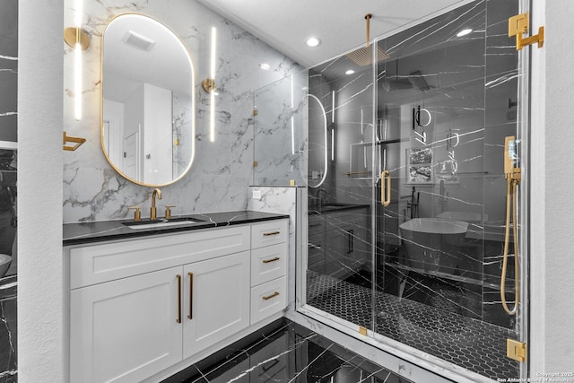 bathroom featuring vanity, tile walls, and a shower with shower door