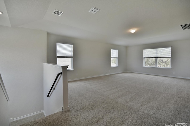 unfurnished room featuring light colored carpet