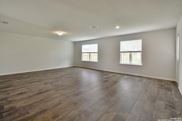 spare room featuring dark wood-type flooring