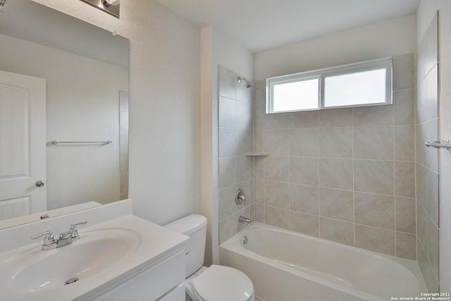 full bathroom featuring vanity, toilet, and tiled shower / bath