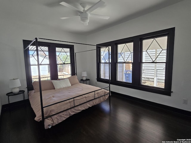 bedroom with ceiling fan and dark hardwood / wood-style flooring