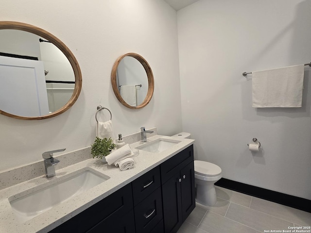 bathroom featuring tile patterned flooring, vanity, and toilet