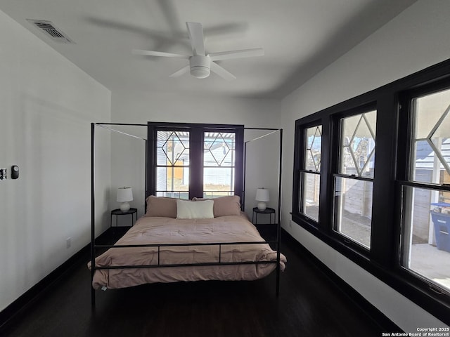 bedroom with multiple windows and ceiling fan