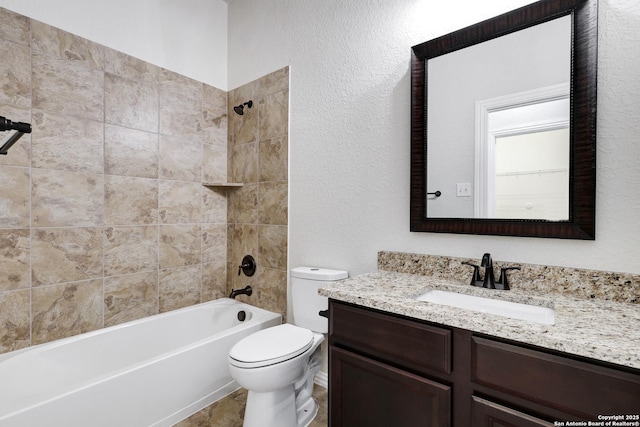 full bathroom featuring toilet, vanity, and tiled shower / bath