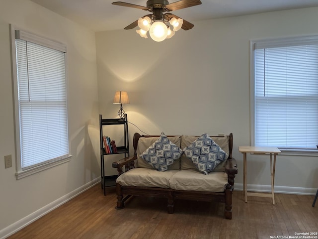 sitting room featuring hardwood / wood-style floors, ceiling fan, and a healthy amount of sunlight