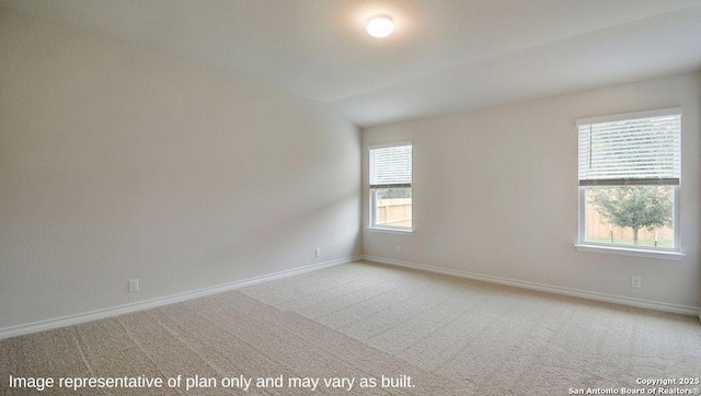 carpeted spare room featuring plenty of natural light