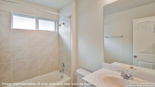 full bathroom featuring vanity, tiled shower / bath combo, and toilet