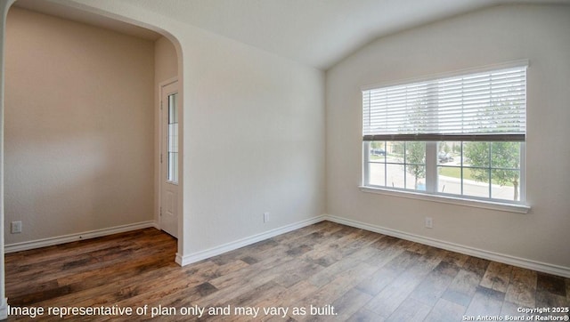 unfurnished room featuring lofted ceiling and dark wood-type flooring