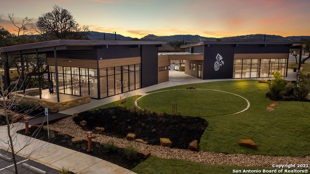 yard at dusk featuring a mountain view