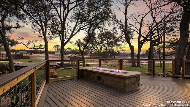 deck at dusk featuring a fire pit