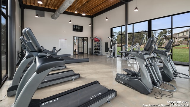 exercise room with a towering ceiling