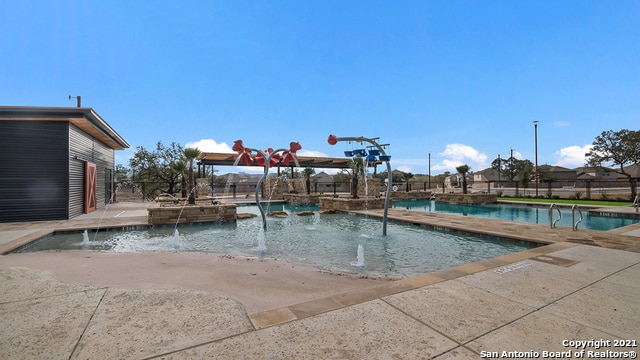 view of pool featuring pool water feature and a patio area