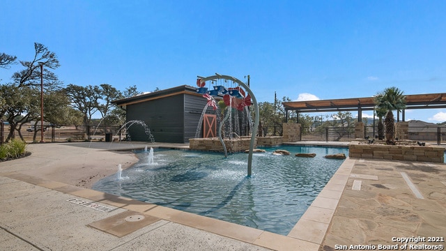 view of pool with pool water feature