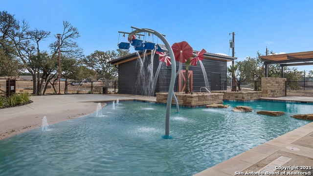 view of swimming pool featuring pool water feature