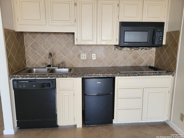 kitchen with backsplash, sink, black appliances, dark stone countertops, and tile patterned flooring