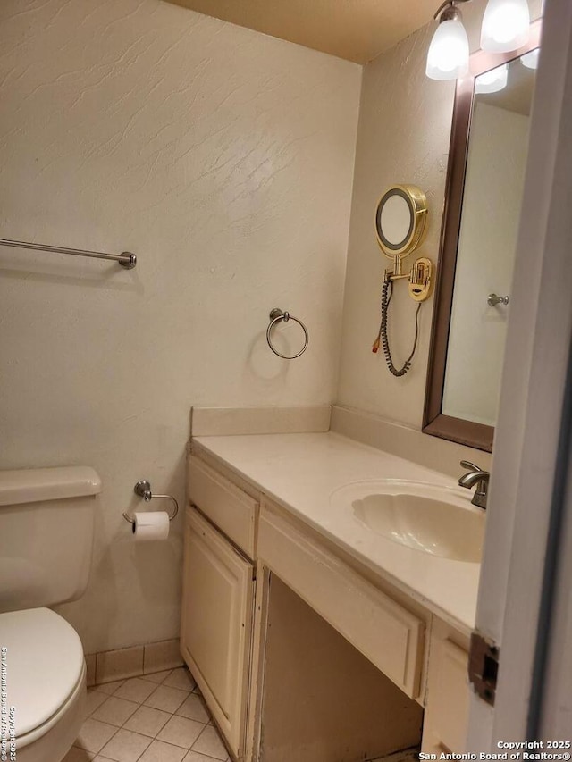 bathroom featuring tile patterned flooring, vanity, and toilet