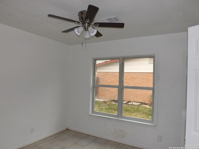 spare room with ceiling fan