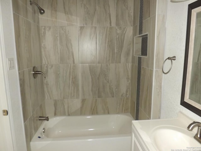 bathroom featuring vanity and tiled shower / bath combo