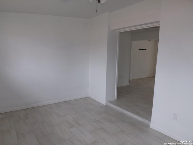 empty room featuring light wood-type flooring and ceiling fan