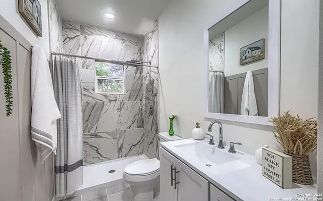 bathroom with toilet, vanity, and a shower with shower curtain