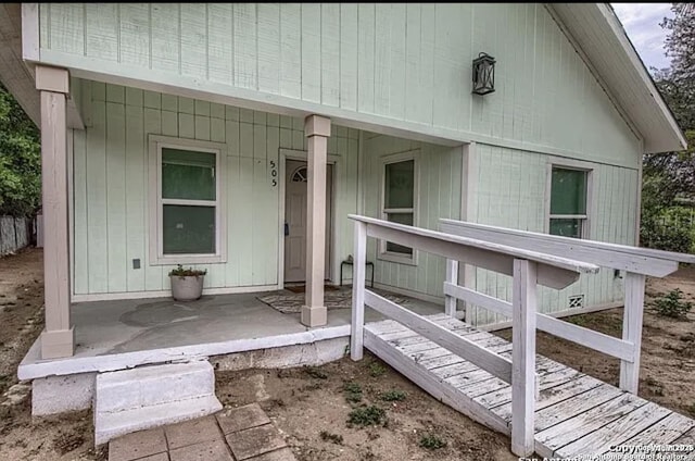 view of exterior entry featuring a porch