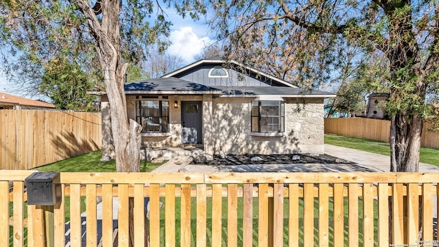 bungalow-style house featuring a front yard