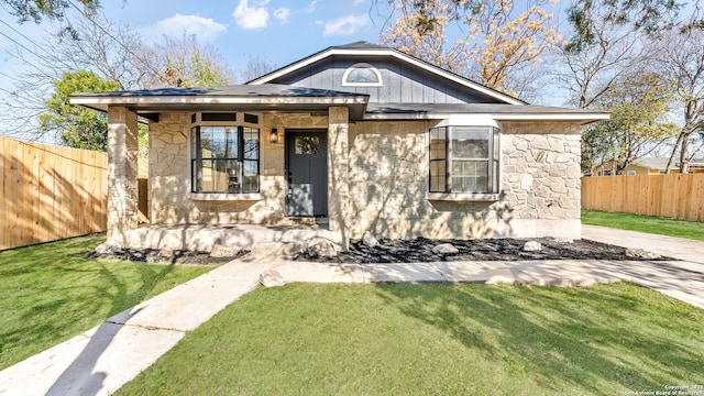 bungalow-style home featuring a front yard