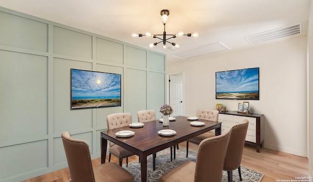 dining area featuring a chandelier and light hardwood / wood-style floors