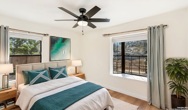 bedroom with ceiling fan and light wood-type flooring