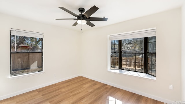 empty room with ceiling fan and light hardwood / wood-style floors