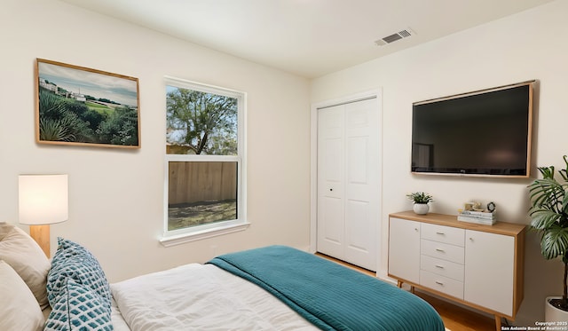 bedroom featuring light hardwood / wood-style floors and a closet