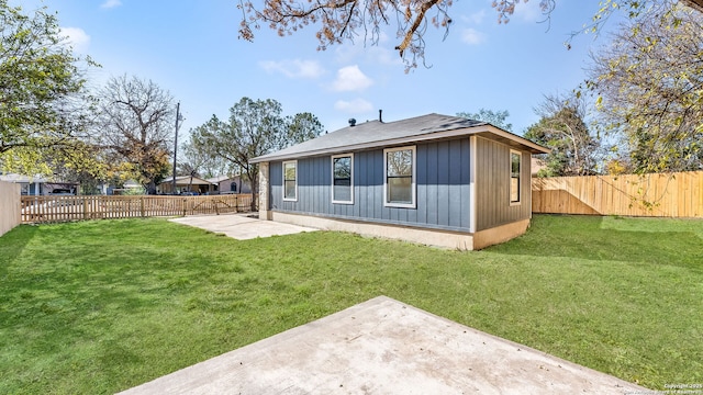 rear view of property with a lawn and a patio area