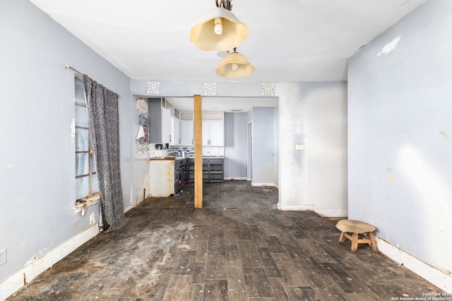 unfurnished dining area featuring dark hardwood / wood-style floors