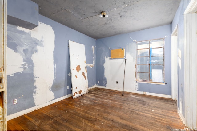 unfurnished room featuring dark hardwood / wood-style floors