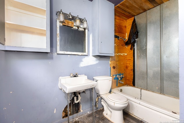 bathroom with a tub to relax in, sink, and toilet