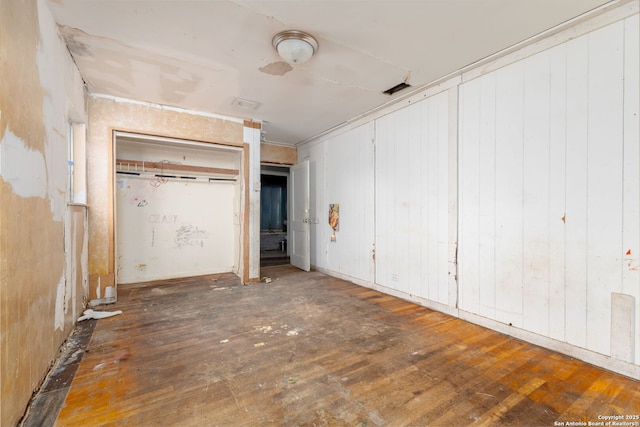 unfurnished bedroom with dark hardwood / wood-style floors