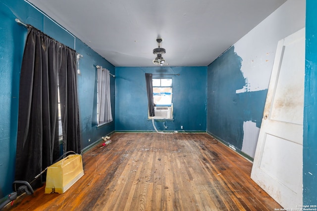 unfurnished room featuring dark hardwood / wood-style flooring and cooling unit