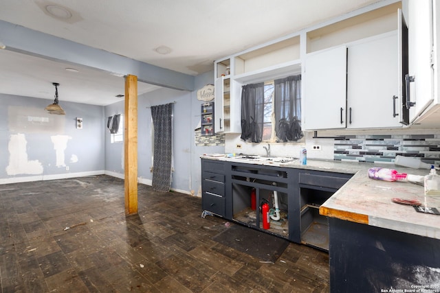 kitchen with decorative backsplash, white cabinets, dark wood-type flooring, and decorative light fixtures