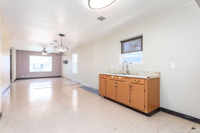 kitchen featuring sink, hanging light fixtures, and ceiling fan