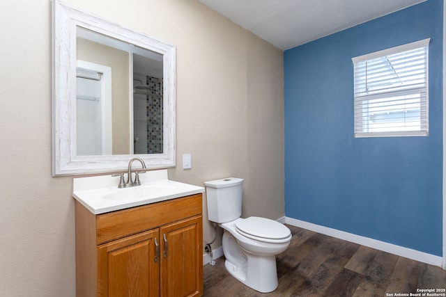 bathroom with vanity, hardwood / wood-style floors, and toilet