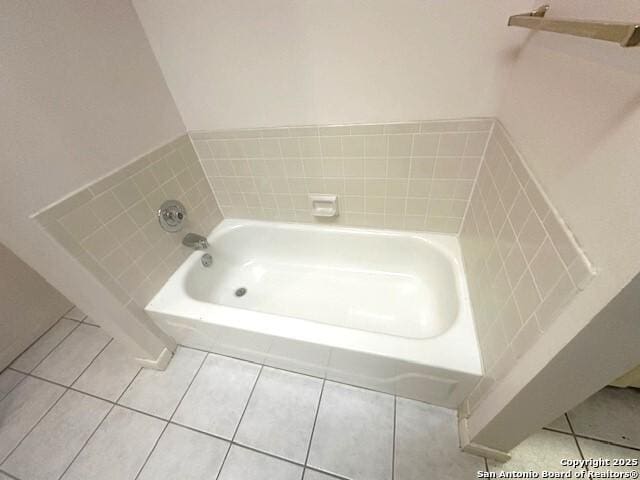 bathroom featuring tile patterned floors and a bath