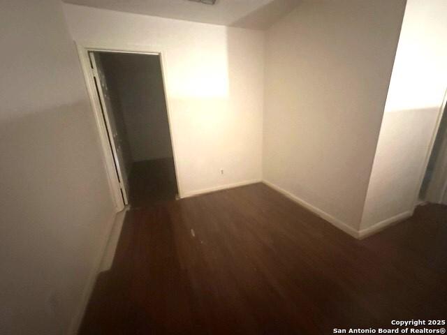 hallway with dark hardwood / wood-style flooring